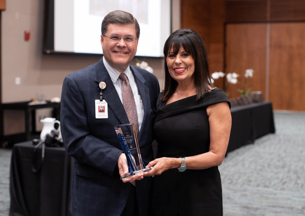 Louis Smith, NGHS president of Acute and Post-Acute Operations, recognizes Dianne Appling, Lifeline coordinator, for the Lifeline Program's 35 years of service.