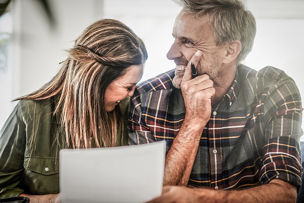 Shot of a mature couple managing their paperwork together at home