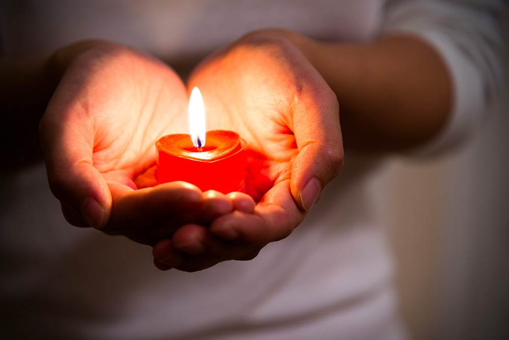 Stock image holding a candle