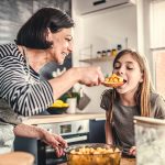 Stock image of grandmother and granddaughter in kitchen