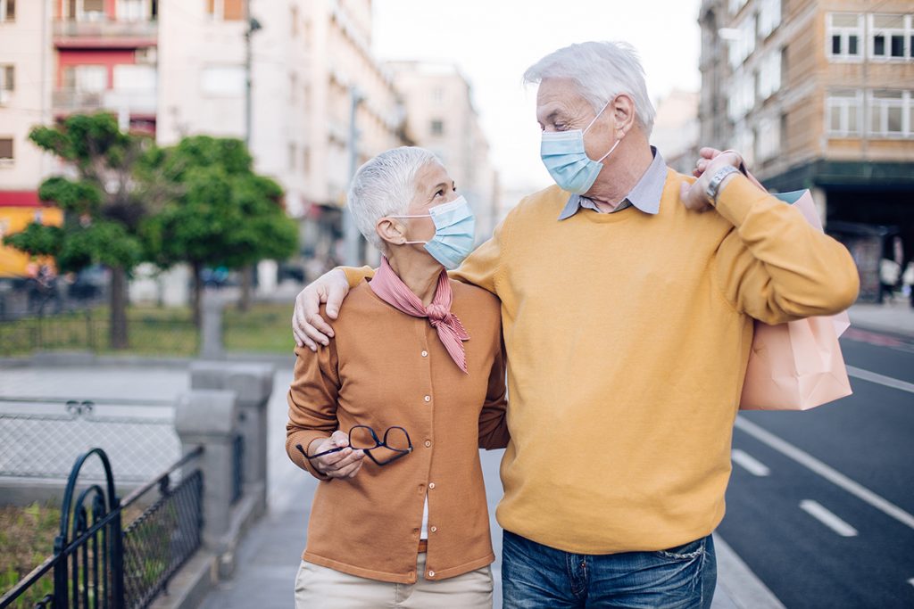 Older couple walking down a city street