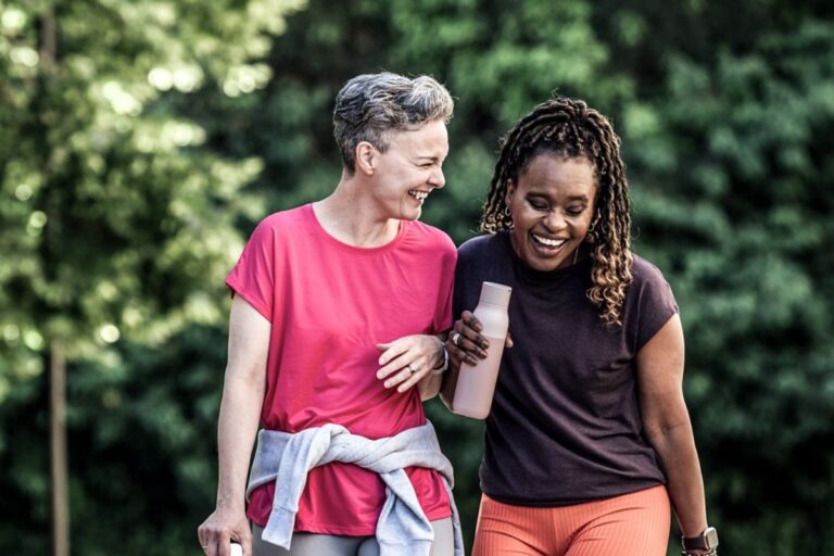 two women walking together in nature