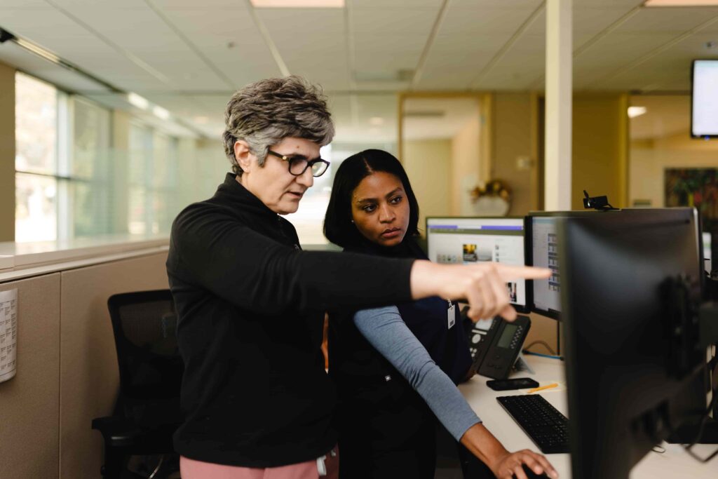 two women looking at computer screen