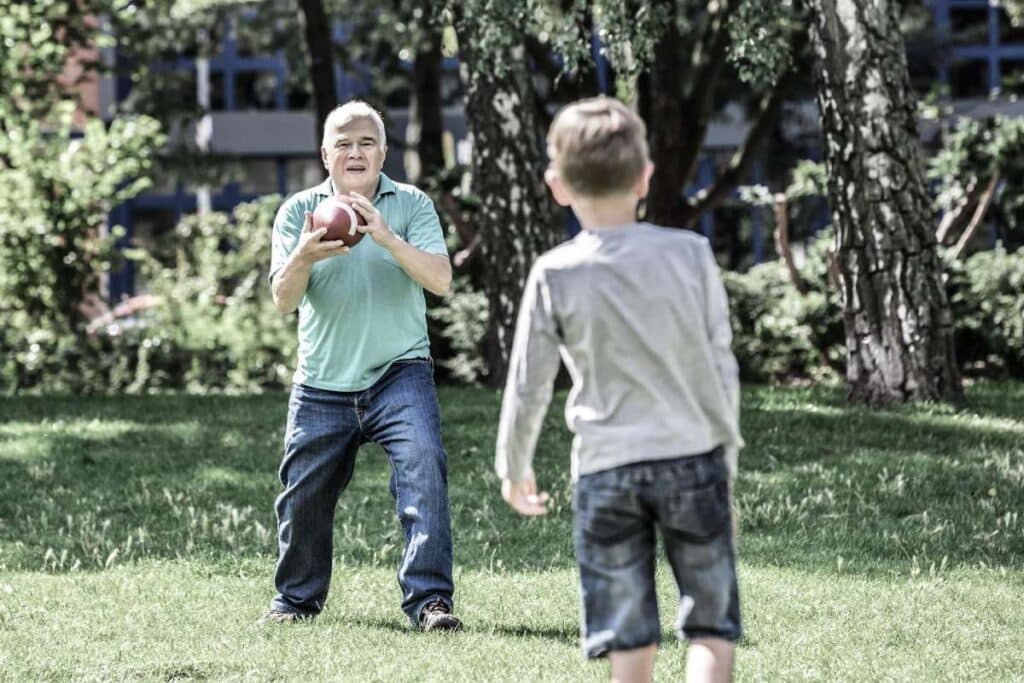 father and son playing football