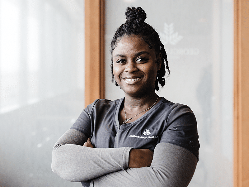 Registered Nurse standing in hallway