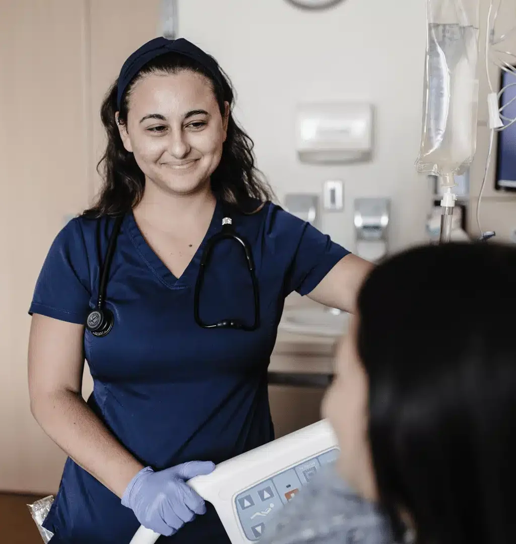 Registered Nurse speaking with a patient in a hospital room