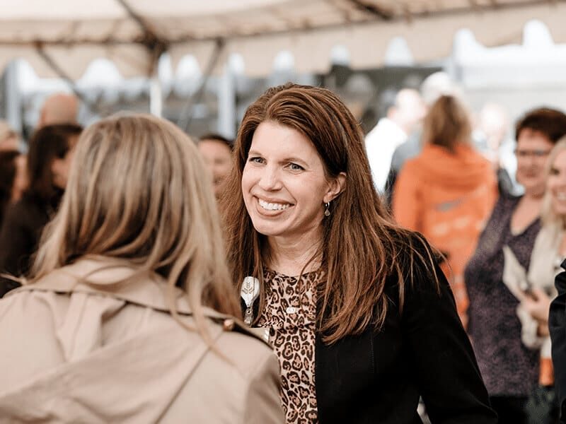 Two healthcare professionals interacting at event