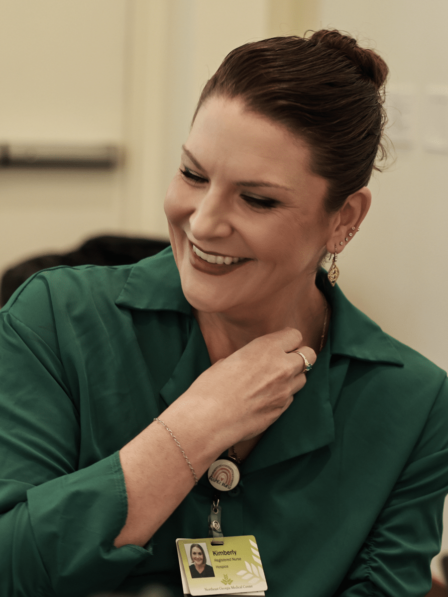 Smiling female healthcare employee sitting in chair