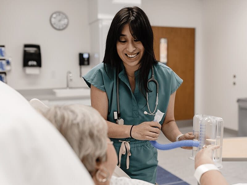 Respiratory therapist interacting with patient