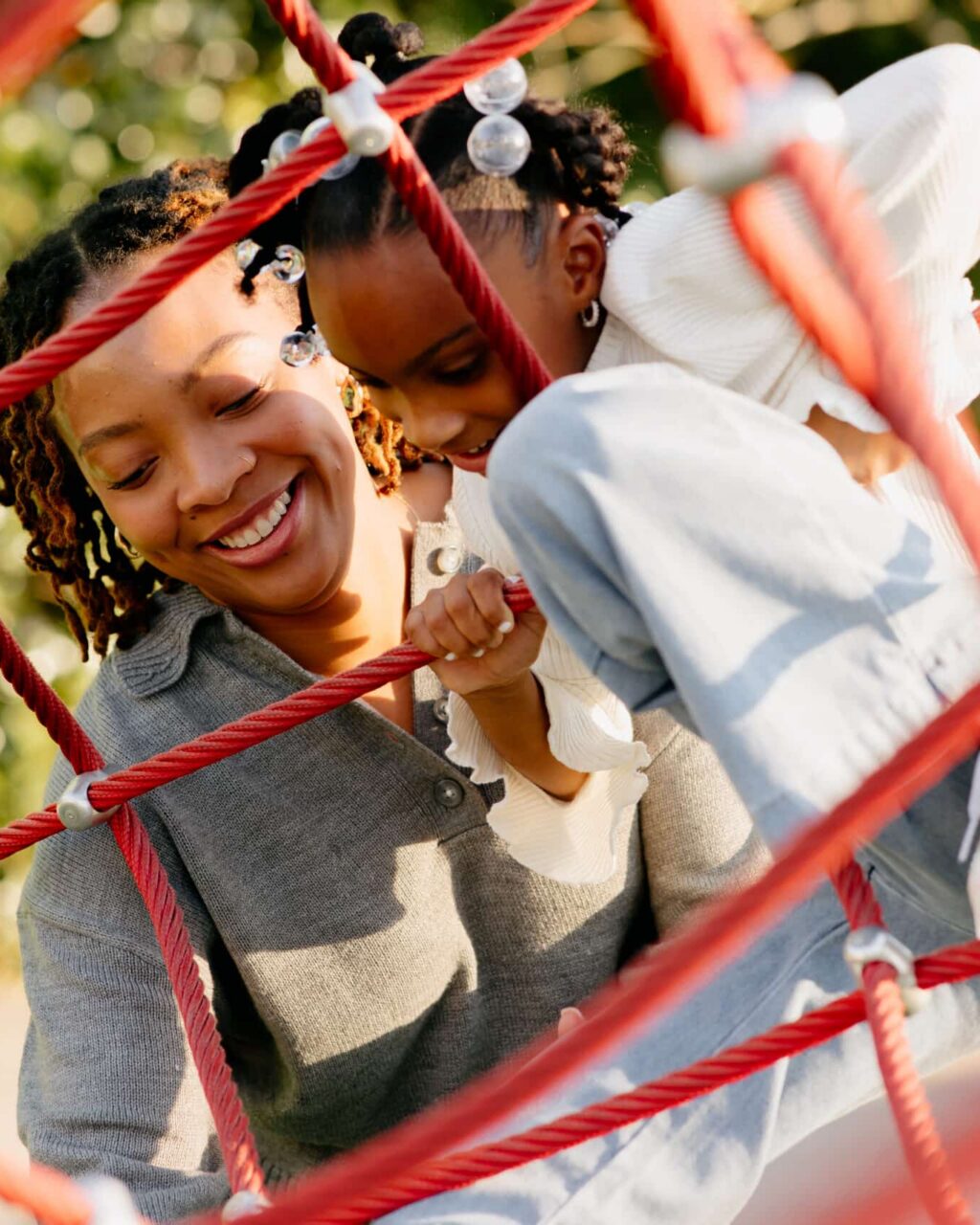 Woman playing at park with daughter.